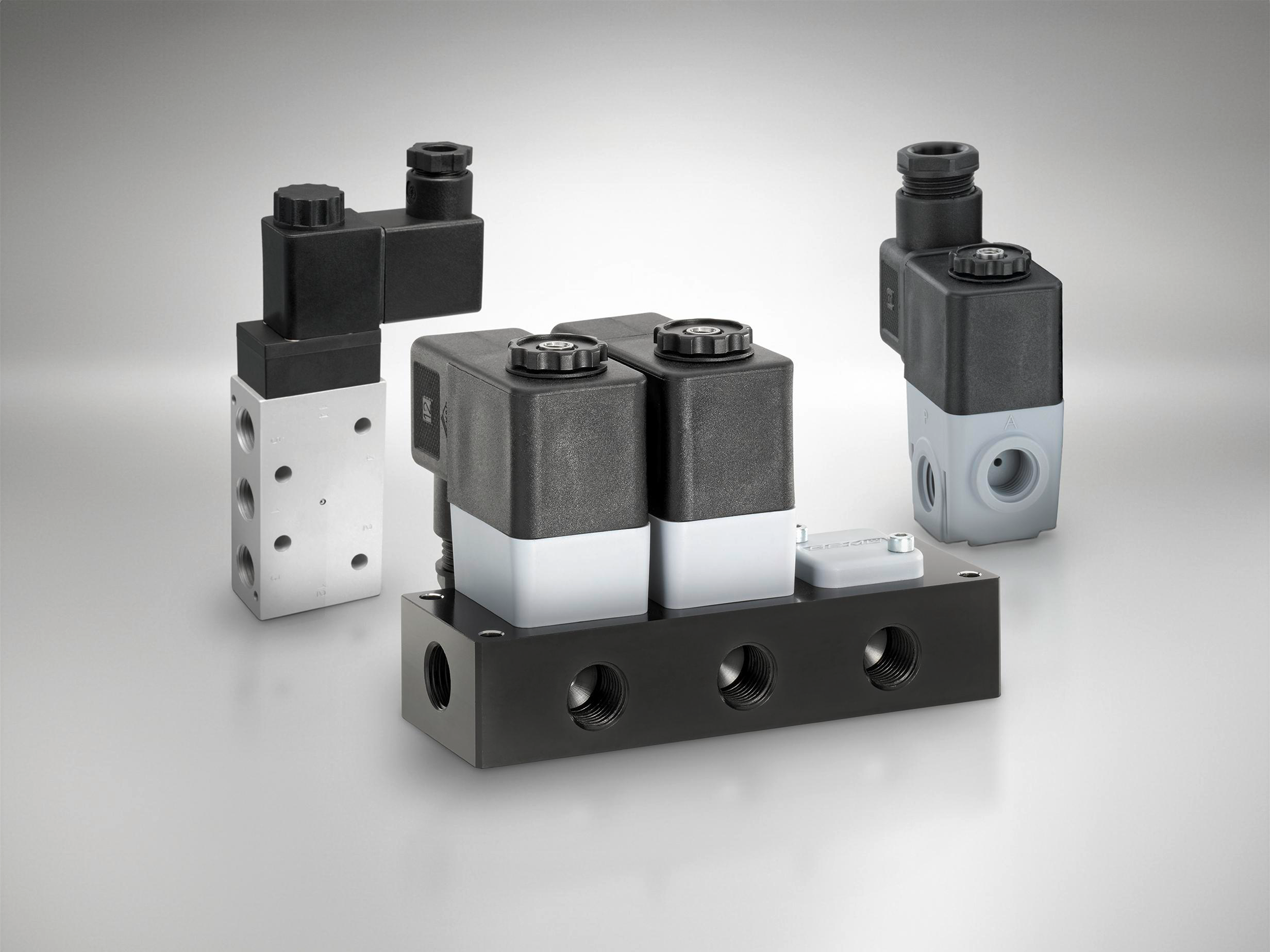 Three GEMÜ pilot valves for controlling pneumatic main valves.